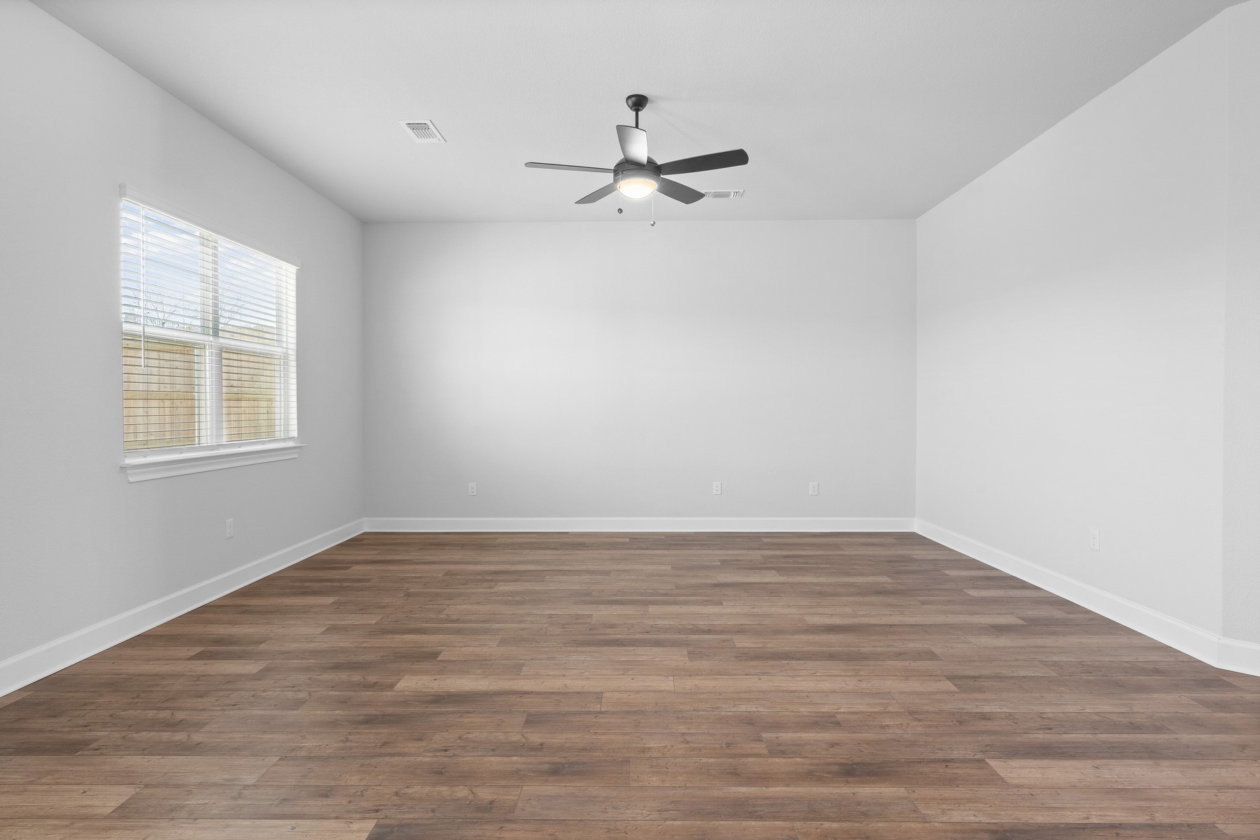 9709 Gladsome Path Manor Manor, TX 78653 - Photo 5 of 15 a view of empty room with wooden floor and fan
