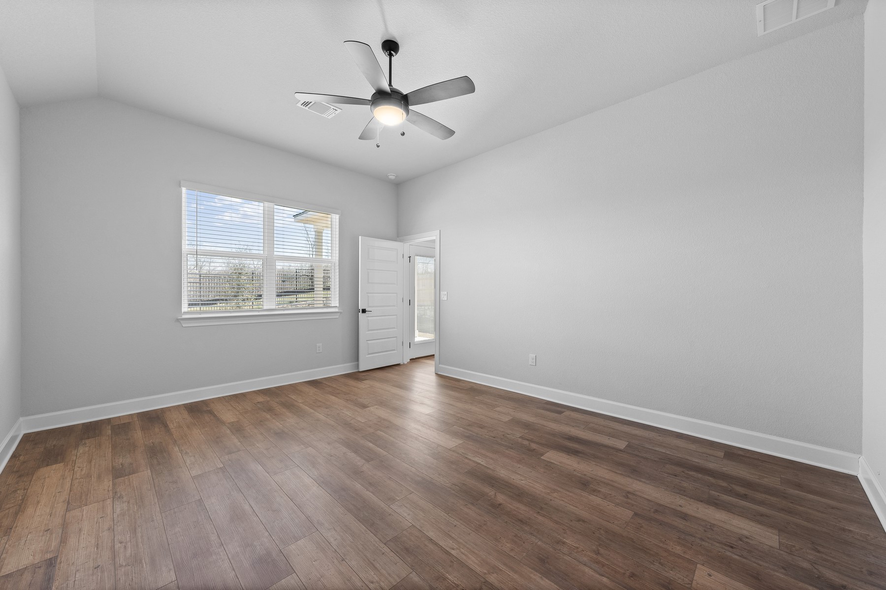 9709 Gladsome Path Manor Manor, TX 78653 - Photo 6 of 15 wooden floor in an empty room with a window