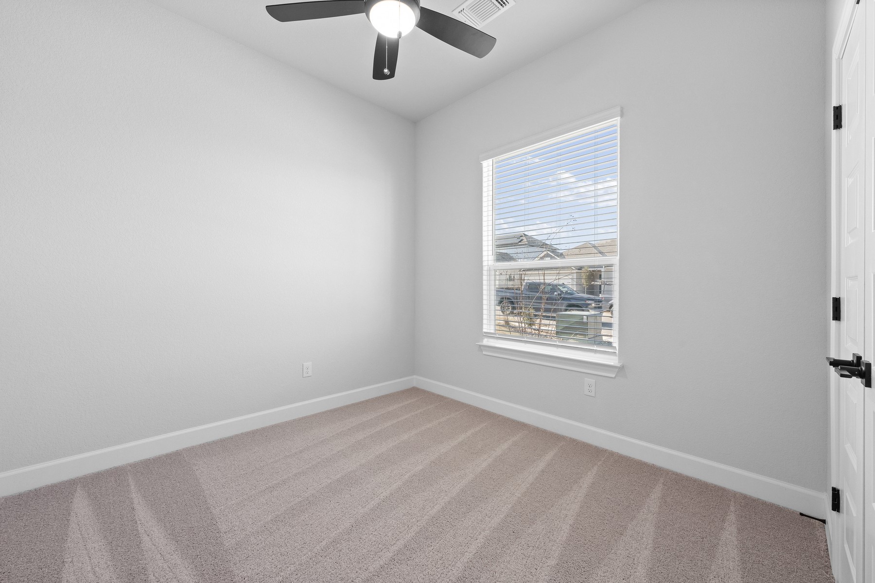 9709 Gladsome Path Manor Manor, TX 78653 - Photo 8 of 15 an empty room with a window and a fan