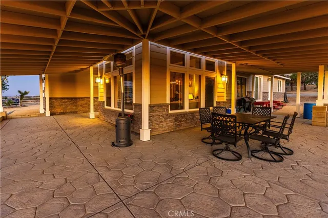 a view of a hallway with entryway windows a chandelier and a kitchen view