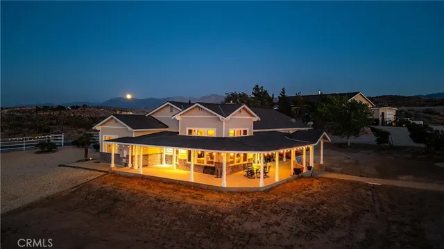 a view of a patio with table and chairs