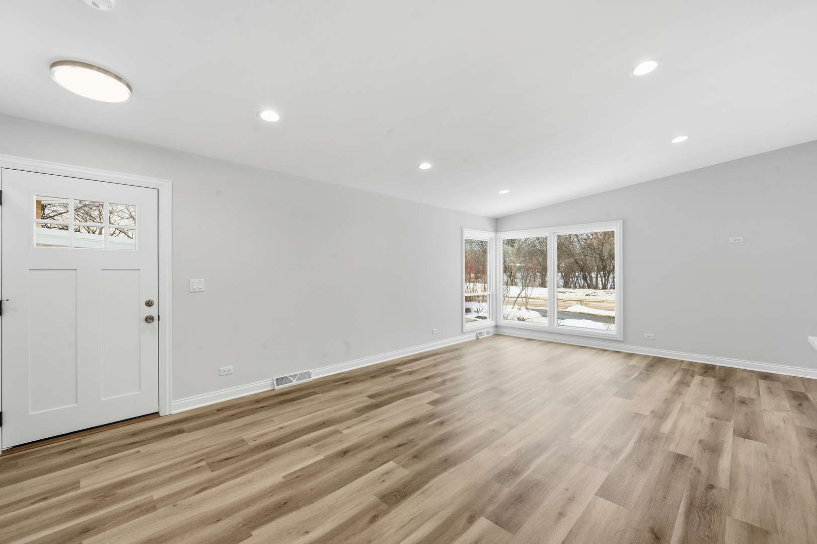 703 West Man A Wa Trail Mount Mount Prospect, IL 60056 - Photo 13 of 35 a view of an empty room with wooden floor and a window