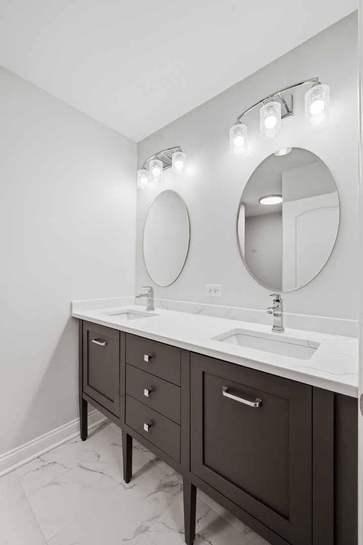 703 West Man A Wa Trail Mount Mount Prospect, IL 60056 - Photo 14 of 35 a bathroom with a double vanity sink and a mirror