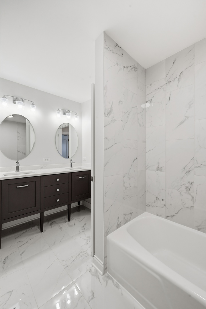 703 West Man A Wa Trail Mount Mount Prospect, IL 60056 - Photo 16 of 35 a bathroom with a double vanity sink and mirror
