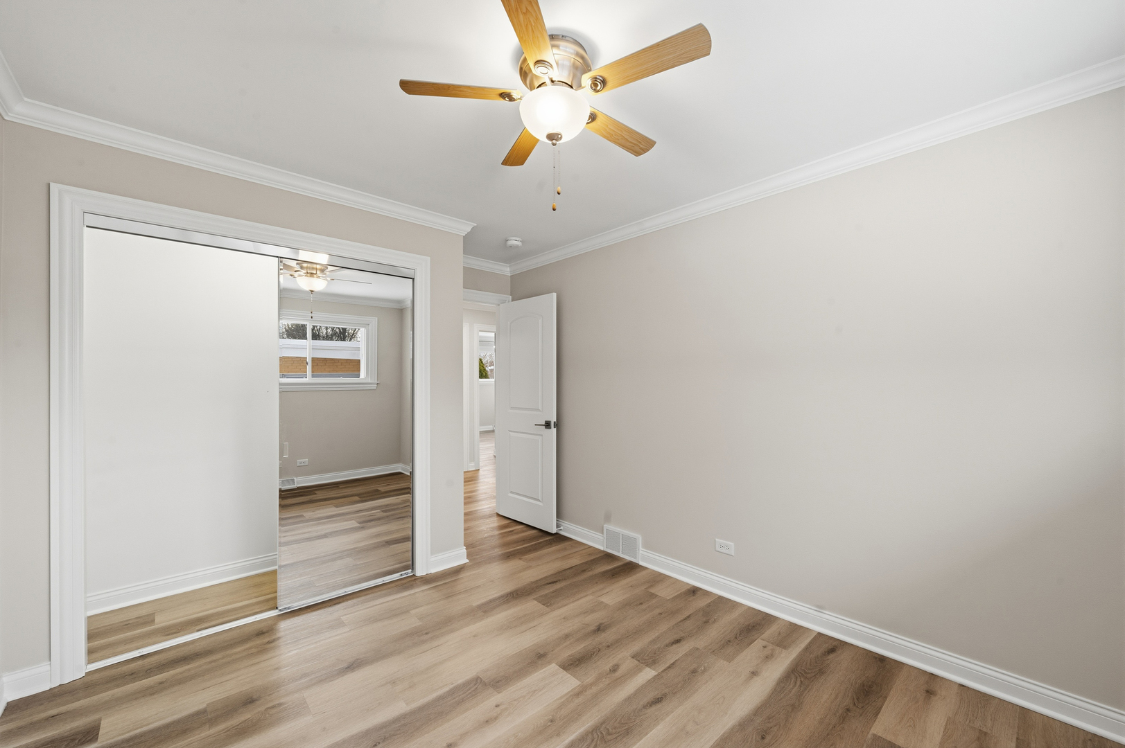 703 West Man A Wa Trail Mount Mount Prospect, IL 60056 - Photo 19 of 35 wooden floor in an empty room with a window