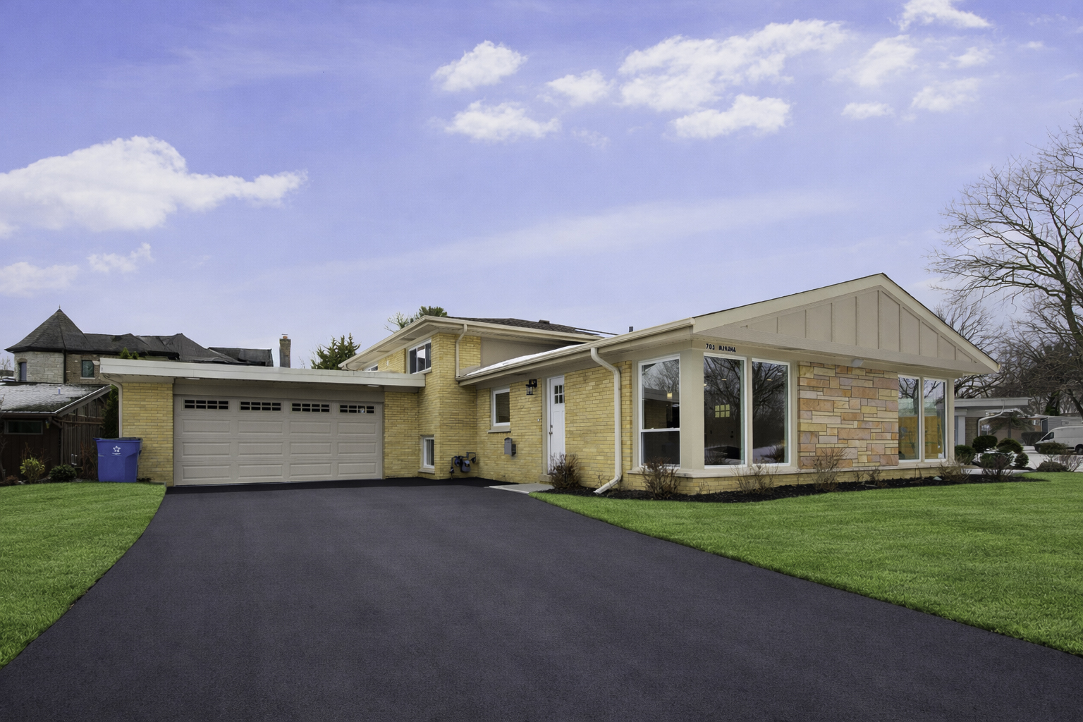 703 West Man A Wa Trail Mount Mount Prospect, IL 60056 - Photo 4 of 35 a view of a white house in front of a big yard with plants and large trees