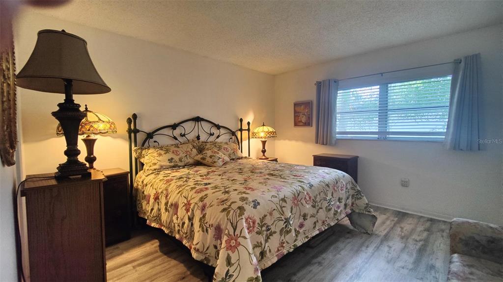 952 Virginia Street, Unit 103 Dunedin, FL 34698 - Photo 12 of 16 a bedroom with a bed and a window
