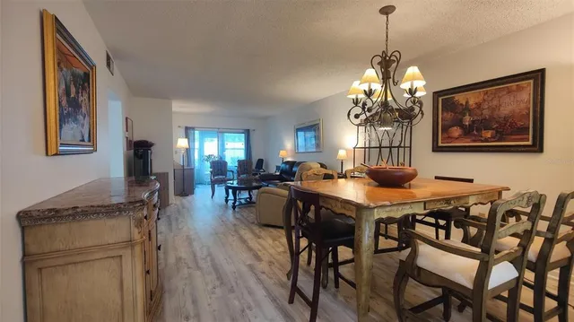 a view of a dining room with furniture and chandelier