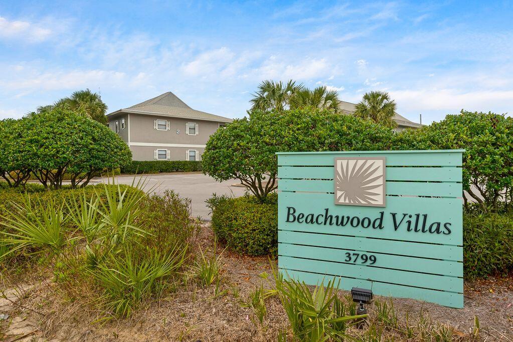 3799 East County Highway 30A, Unit H 2 Santa Rosa Beach, FL 32459 - Photo 1 of 41 a sign that is sitting on a wooden bench in a yard