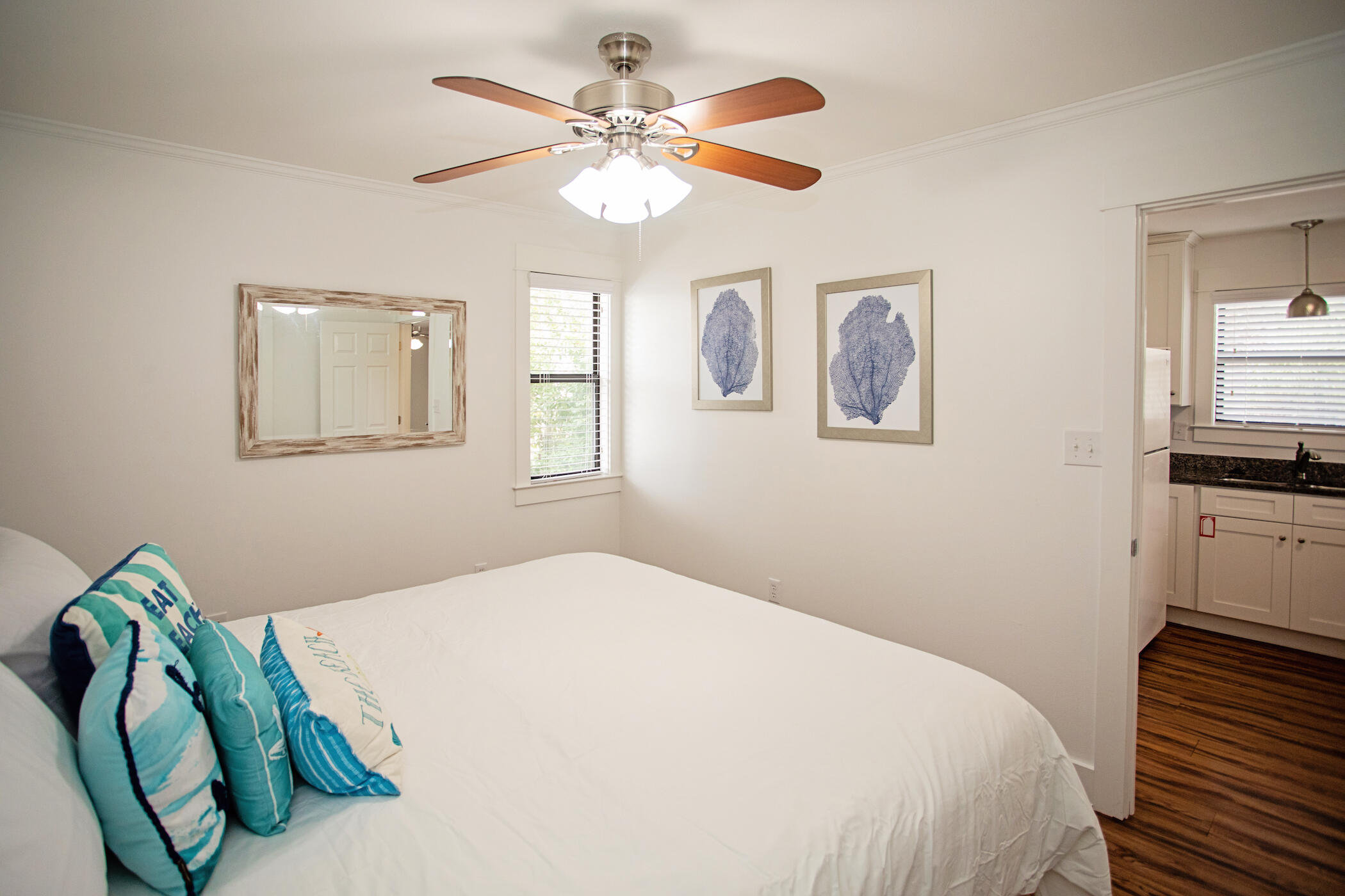 3799 East County Highway 30A, Unit H 2 Santa Rosa Beach, FL 32459 - Photo 19 of 41 a bedroom with a bed and a chandelier
