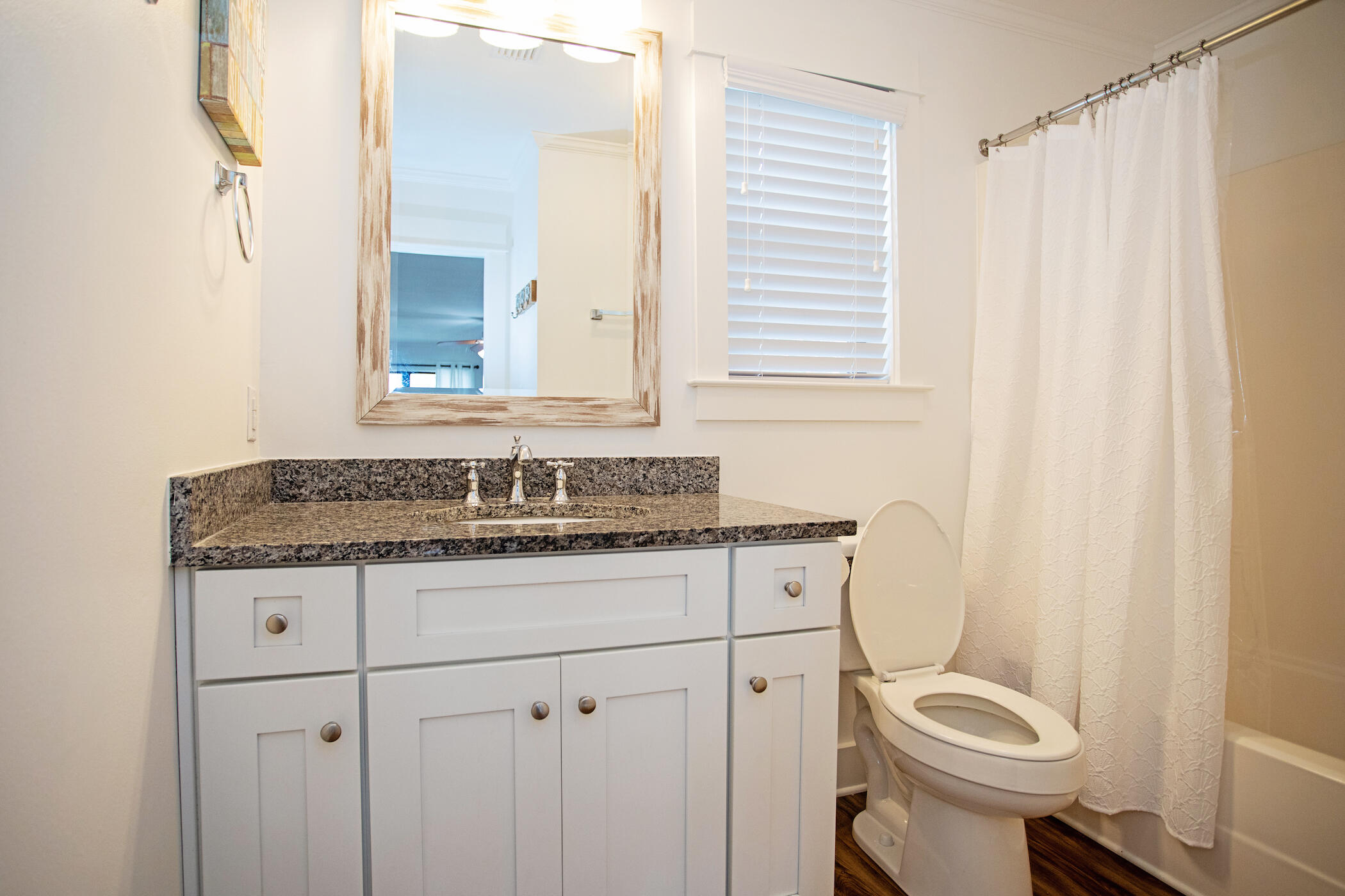 3799 East County Highway 30A, Unit H 2 Santa Rosa Beach, FL 32459 - Photo 24 of 41 a bathroom with a granite countertop toilet sink and mirror