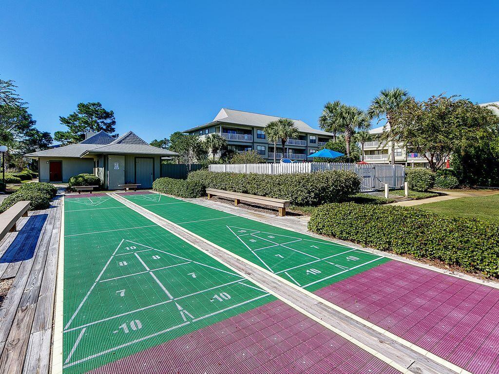 3799 East County Highway 30A, Unit H 2 Santa Rosa Beach, FL 32459 - Photo 26 of 41 a view of a tennis ground with large trees and cars parked in front of it
