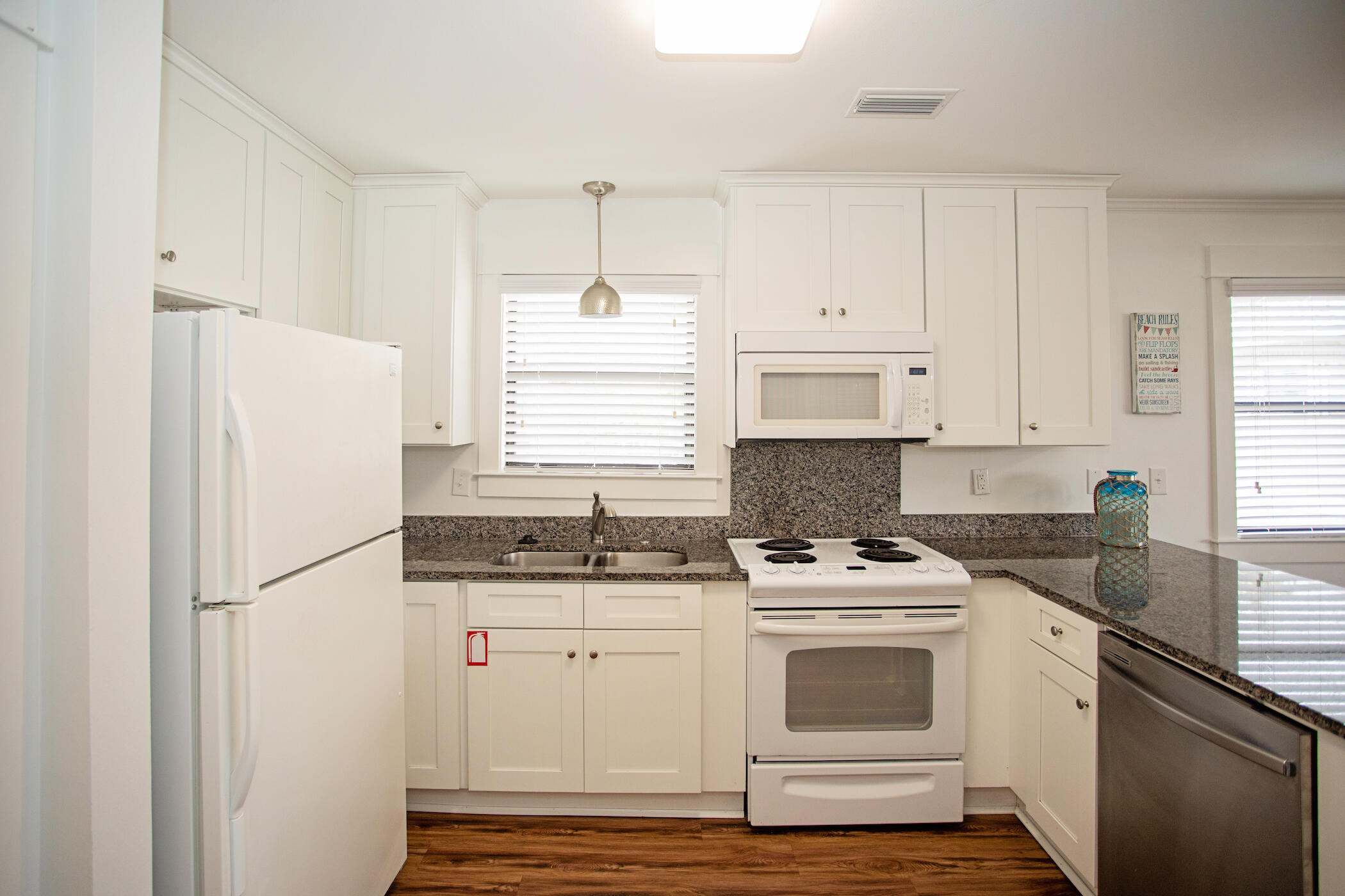 3799 East County Highway 30A, Unit H 2 Santa Rosa Beach, FL 32459 - Photo 7 of 41 a kitchen with granite countertop a sink cabinets stainless steel appliances and window