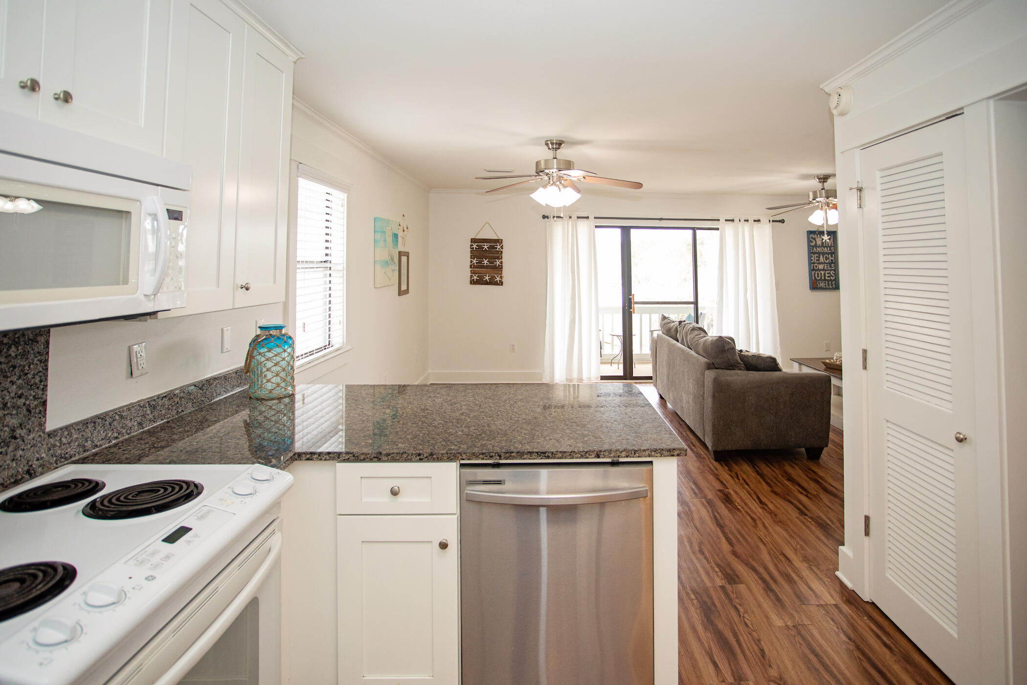 3799 East County Highway 30A, Unit H 2 Santa Rosa Beach, FL 32459 - Photo 8 of 41 a kitchen with granite countertop a sink and a stove top oven