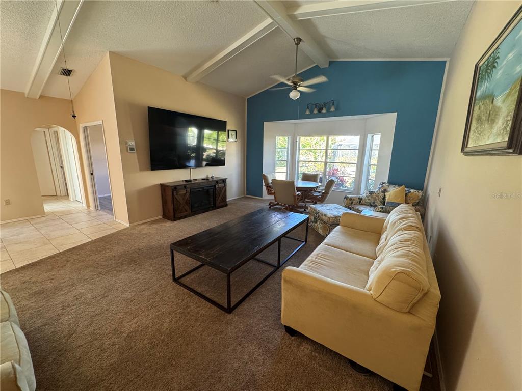 549 Warwick Lane Venice, FL 34293 - Photo 12 of 38 a living room with furniture and a flat screen tv