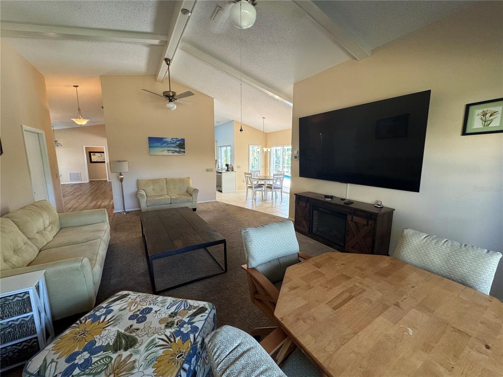 549 Warwick Lane Venice, FL 34293 - Photo 13 of 38 a living room with furniture and a flat screen tv