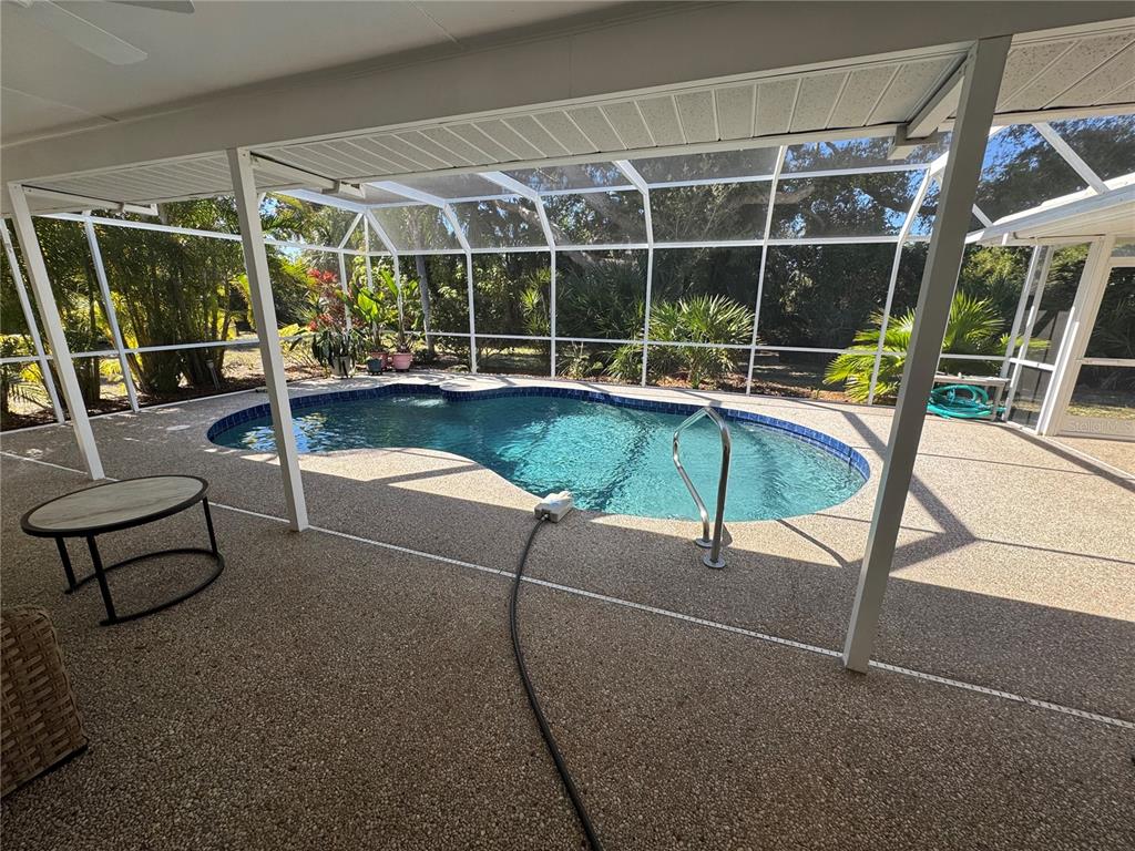 549 Warwick Lane Venice, FL 34293 - Photo 17 of 38 a swimming pool with outdoor seating and flat screen tv