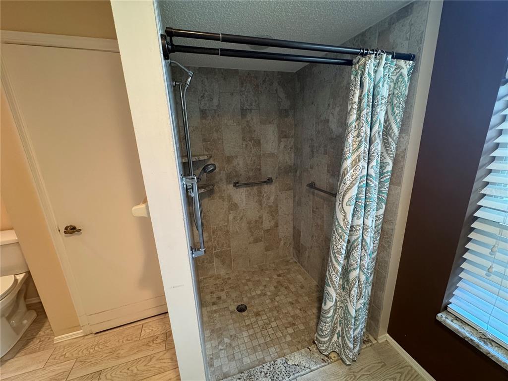 549 Warwick Lane Venice, FL 34293 - Photo 25 of 38 a bathroom with a glass door shower