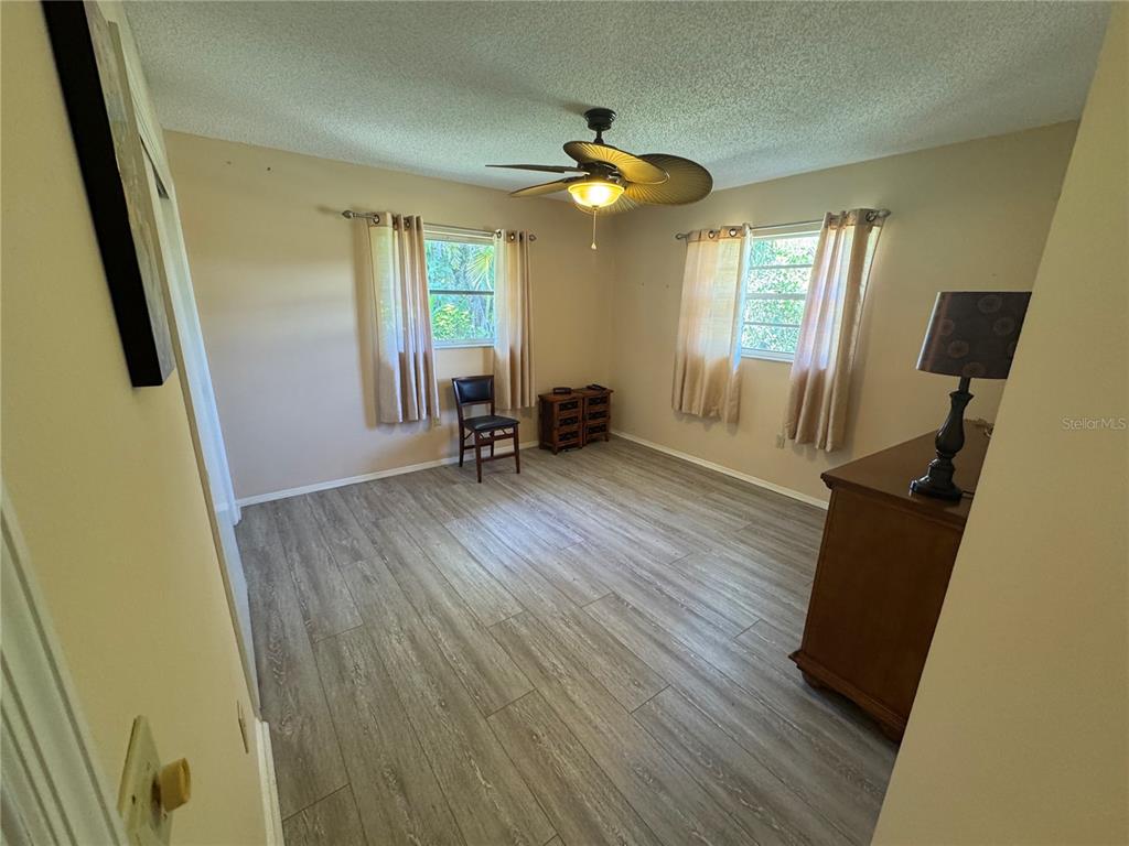 549 Warwick Lane Venice, FL 34293 - Photo 29 of 38 a view of an empty room with wooden floor and a window