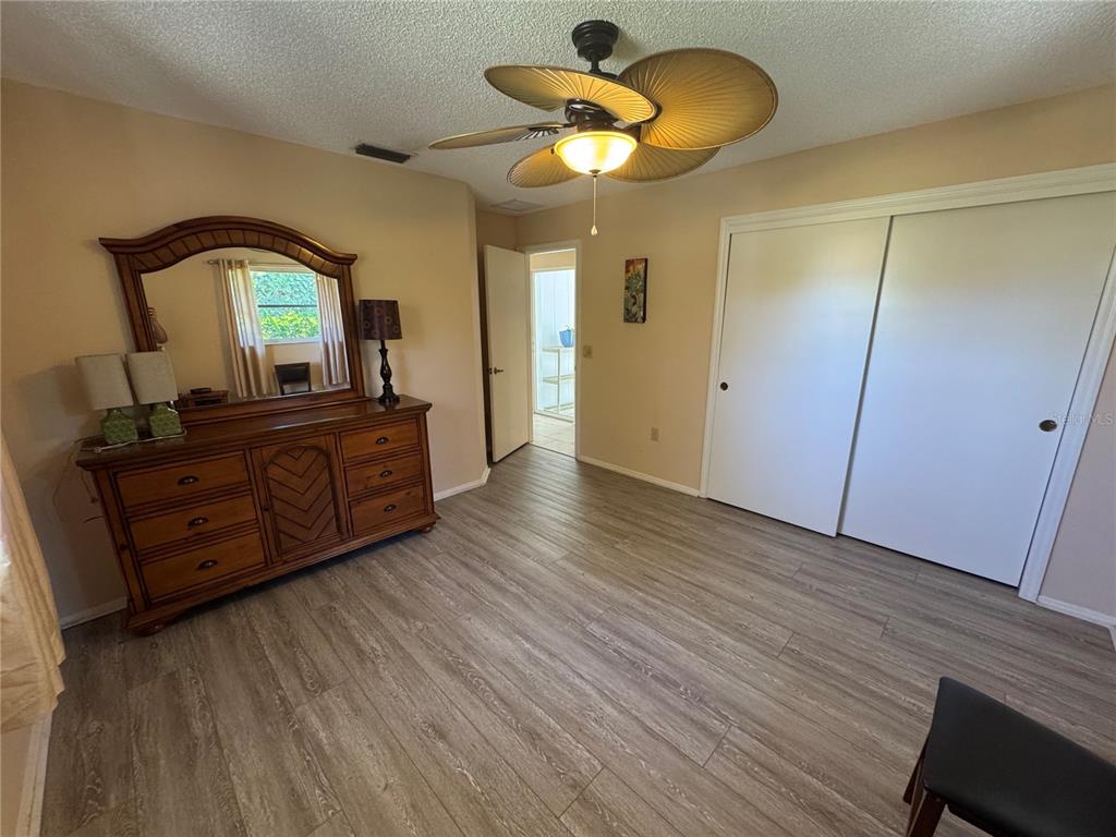 549 Warwick Lane Venice, FL 34293 - Photo 30 of 38 a bedroom with a bed and a dresser