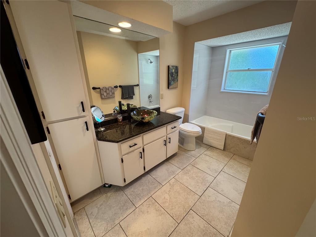 549 Warwick Lane Venice, FL 34293 - Photo 31 of 38 a bathroom with a sink a toilet a mirror and vanity