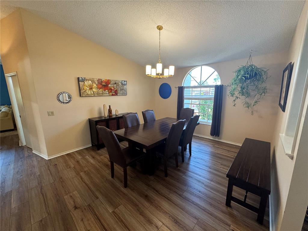 549 Warwick Lane Venice, FL 34293 - Photo 5 of 38 a view of a dining room with furniture window and wooden floor