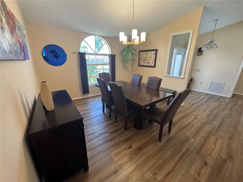 549 Warwick Lane Venice, FL 34293 - Photo 6 of 38 a view of a dining room with furniture window and wooden floor