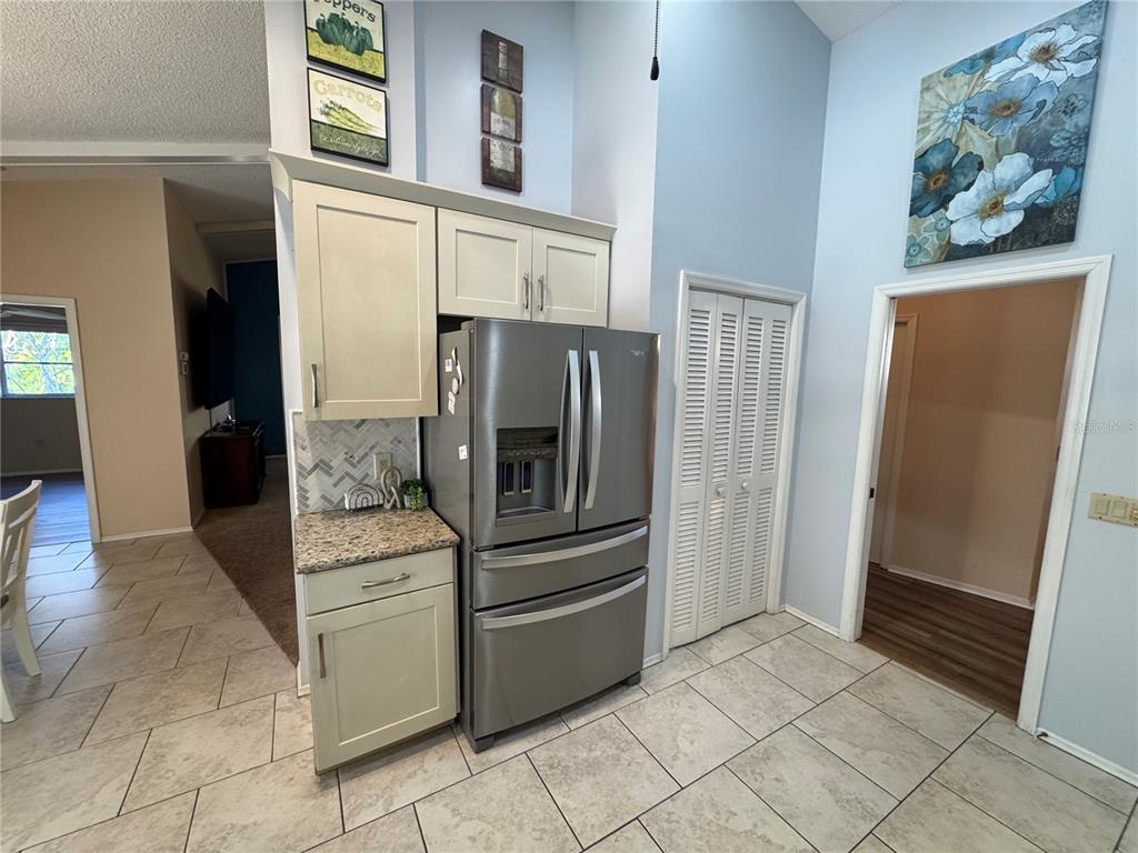 549 Warwick Lane Venice, FL 34293 - Photo 8 of 38 a view of kitchen with furniture and refrigerator