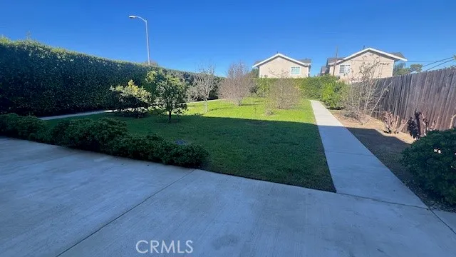 a view of a big house with a big yard and potted plants