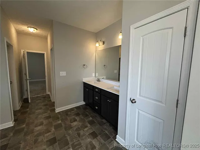 a spacious bathroom with a mirror and a shower
