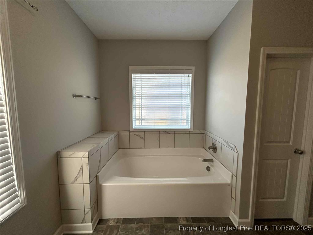 2406 Bankswood (lot 145) Court Hope Mills, NC 28348 - Photo 16 of 25 a bathroom with a bathtub and a window