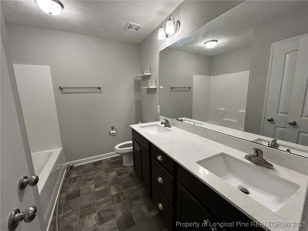 2406 Bankswood (lot 145) Court Hope Mills, NC 28348 - Photo 21 of 25 a bathroom with a sink a toilet and a mirror
