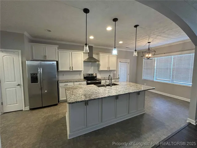 a large kitchen with granite countertop a sink a counter space appliances and cabinets