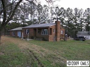 402 Kiser Road Bessemer City, NC 28016 - Photo 1 of 5 a front view of a house with a garden