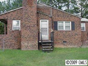 402 Kiser Road Bessemer City, NC 28016 - Photo 4 of 5 a front view of a house with a garden