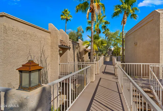 a view of an empty room with workspace and a window