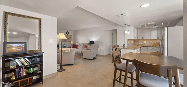 a very nice looking dining room with kitchen island a table and a couch
