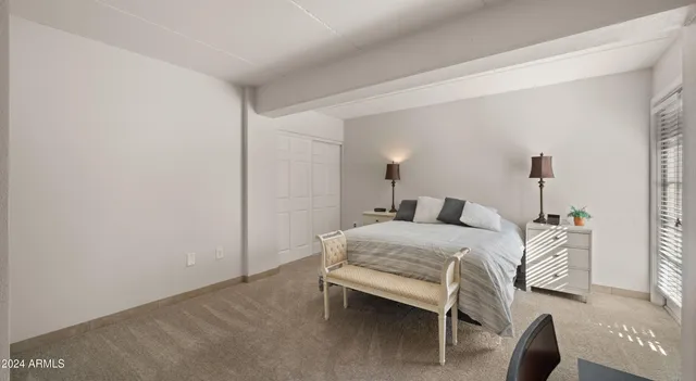 a bedroom with a bed and a chair