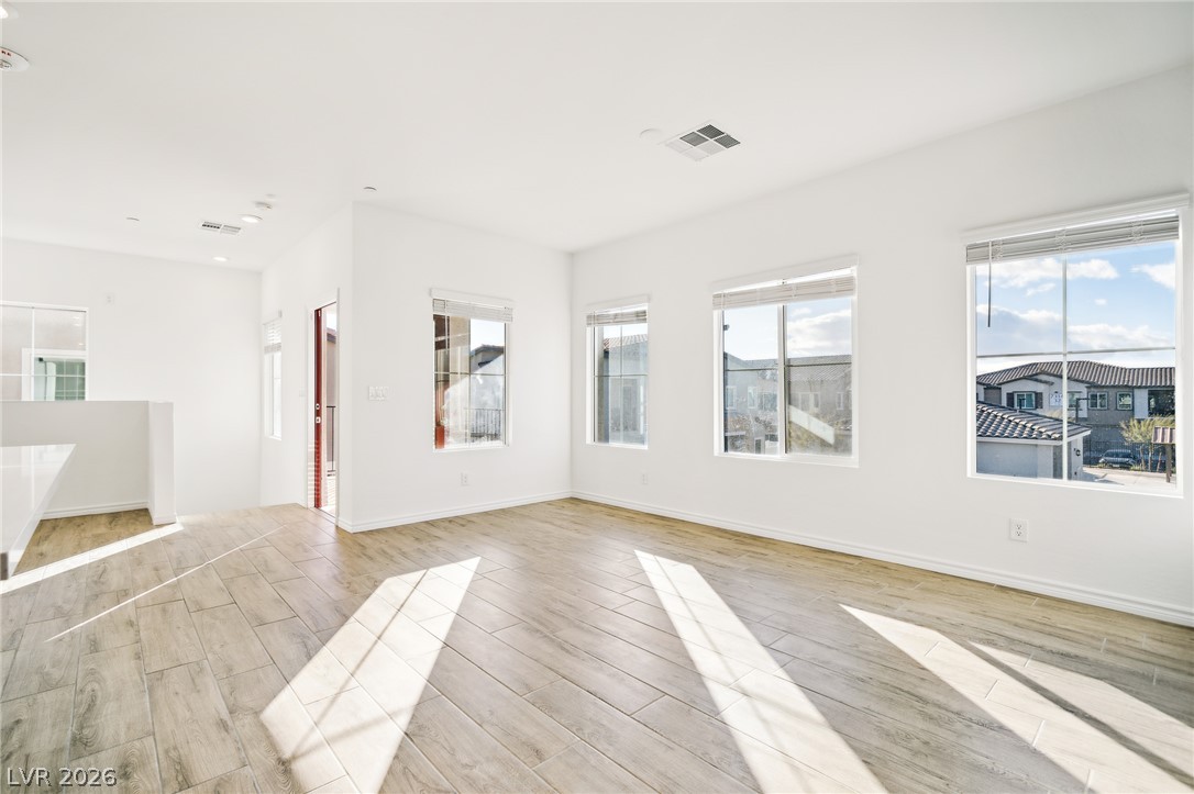 7348 North Decatur Boulevard, Unit 1 North Las Vegas, NV 89084 - Photo 12 of 17 Natural light streams into this pristine living area with durable wood-look tile flooring.