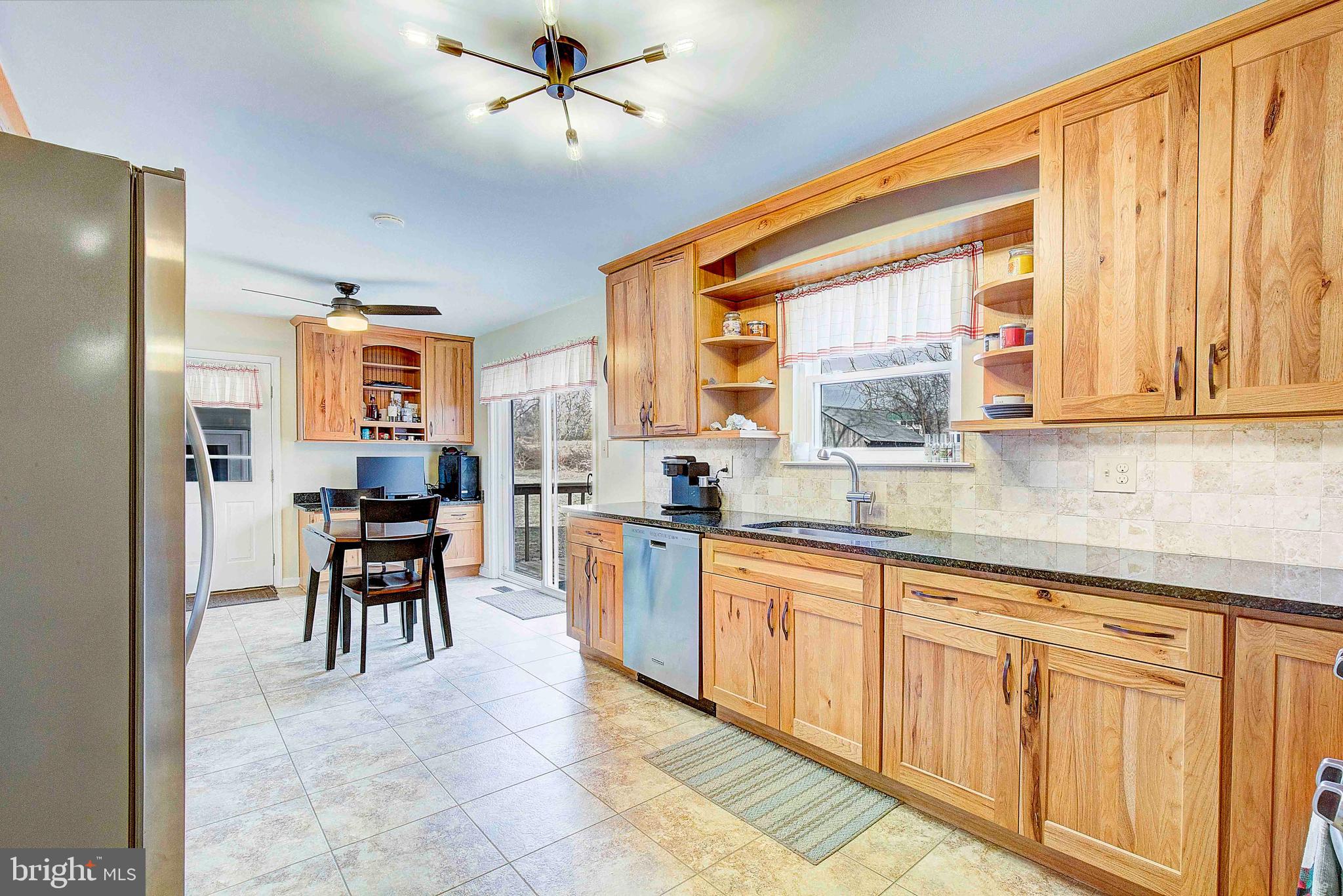 9150 Mackall Road St. Leonard, MD 20685 - Photo 13 of 48 a large kitchen with kitchen island a large window a sink and counter space