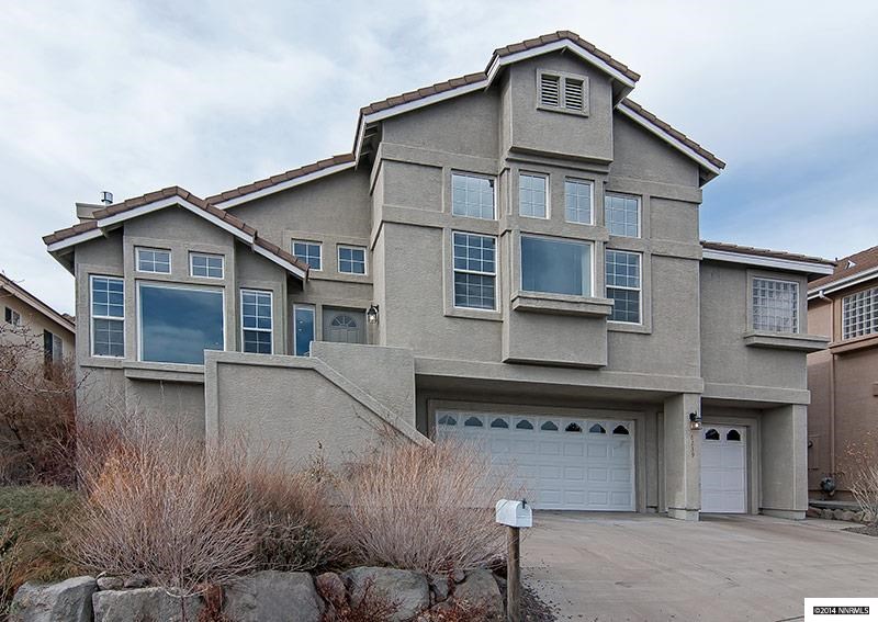 6239 Golden Reno, NV 89519 - Photo 1 of 1 a front view of a house with a yard and garage
