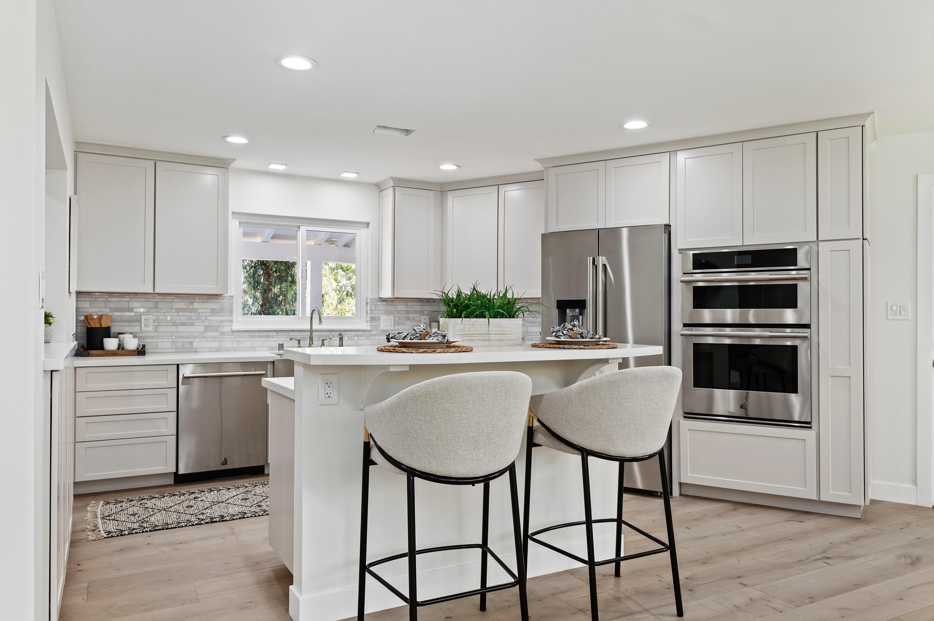 55 Crestview Lane Santa Barbara, CA 93108 - Photo 5 of 28 a kitchen with kitchen island white cabinets and stainless steel appliances