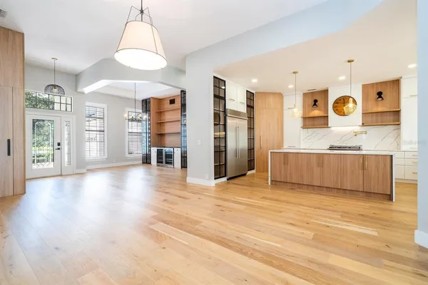 a view of empty room with wooden floor