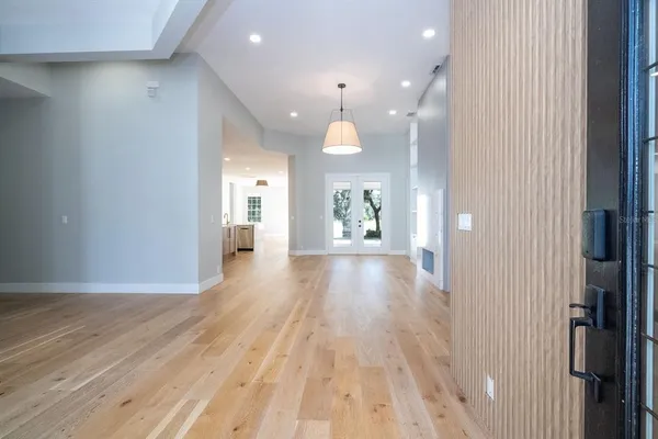 a view of a hallway with wooden floor and closet