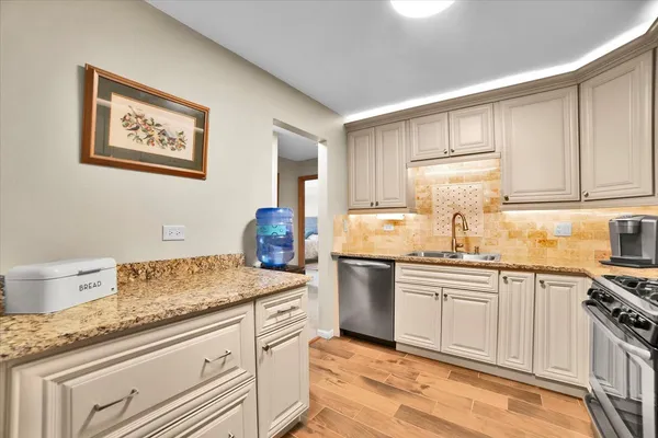 a kitchen with stainless steel appliances a stove a refrigerator and a microwave