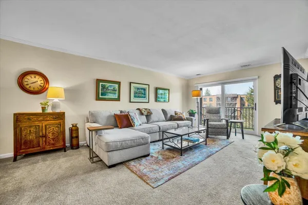 a living room with furniture and a lamp