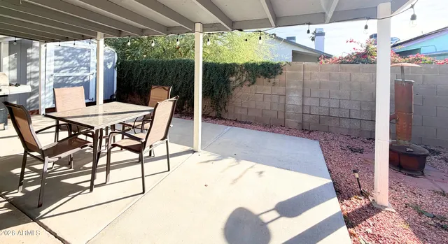 a outdoor dining space with furniture and outdoor view