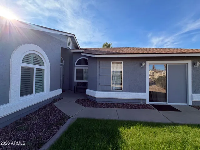 a front view of a house with a garden
