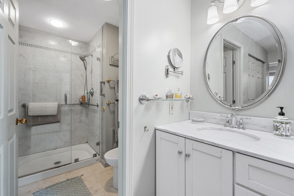 9 Park Avenue, Unit 705 Hull, MA 02045 - Photo 13 of 22 a bathroom with a sink a toilet and shower