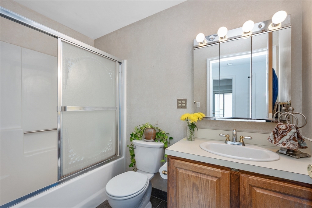 9 Park Avenue, Unit 705 Hull, MA 02045 - Photo 17 of 22 a bathroom with a sink toilet and shower